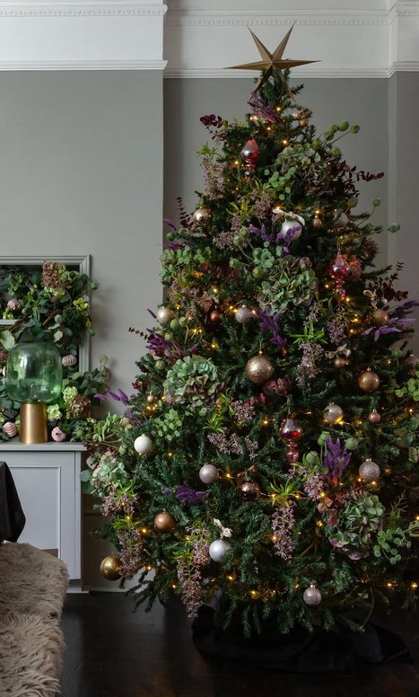 Grand staircase, velvet ribbons in burgundy and gold, fresh garland, warm glow, classic architecture.