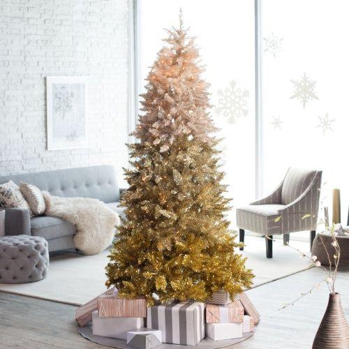Living room wall featuring large ornate gold mirror wrapped with festive pine and gold berry garland.