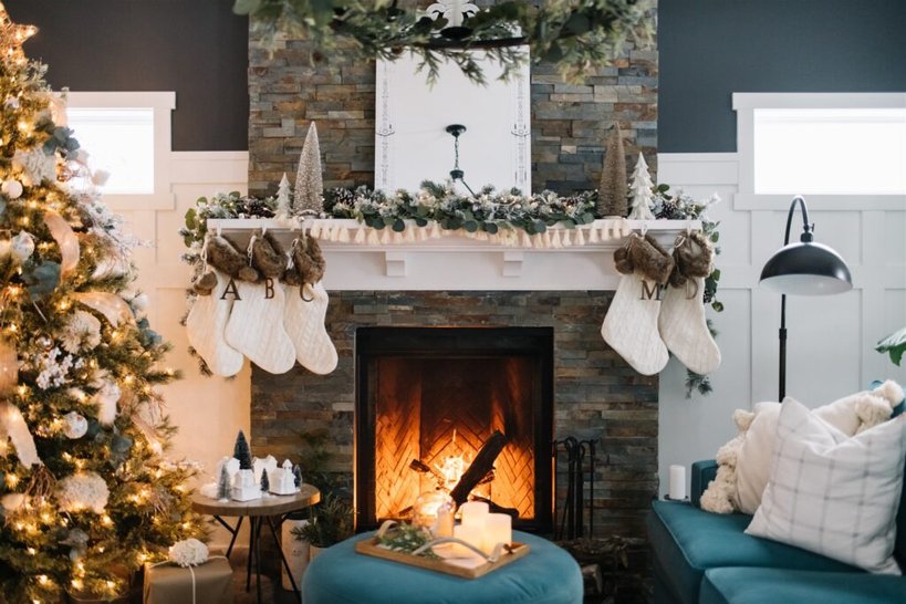 Reading nook, oversized wool throw, faux fur pillow, floor lamp, basket of books, soft holiday decor.