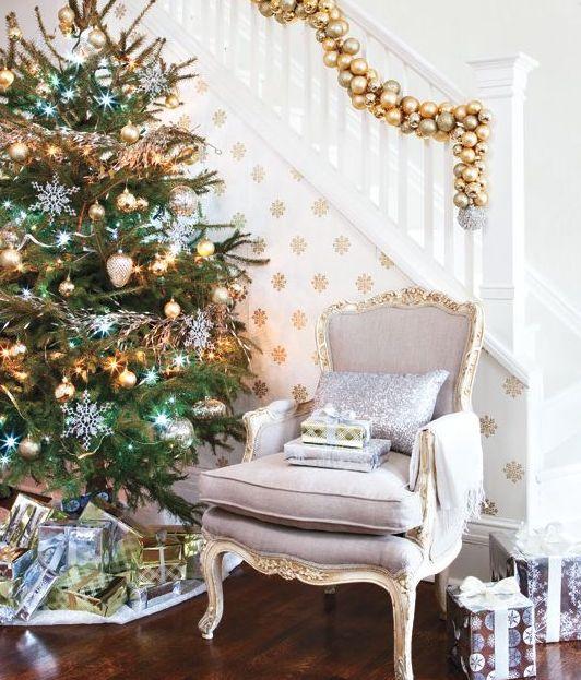 Fireplace mantel featuring satin gold stockings, heavy brass holders, and warm candlelight.