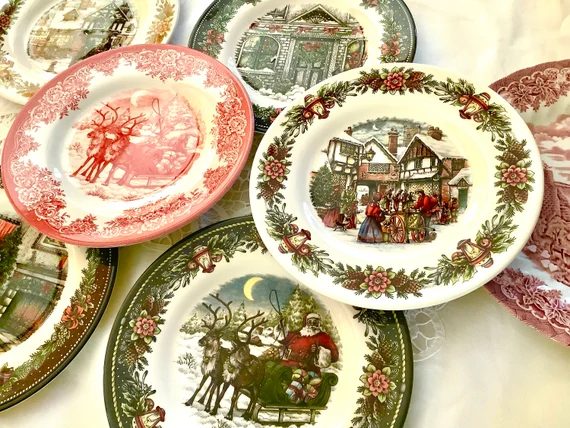 Playful dining area, candy cane stripe china, bright red accents, white wood table, cheerful lighting.