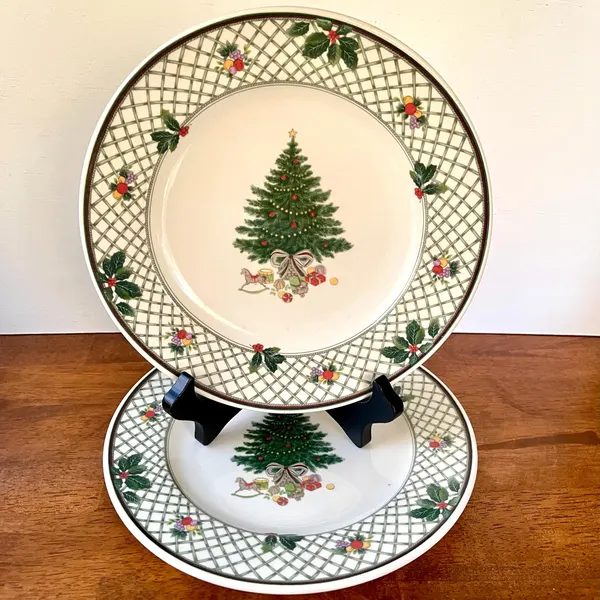 Dining nook, evergreen branch china, wooden placemats, soft lighting, minimalist festive decor.