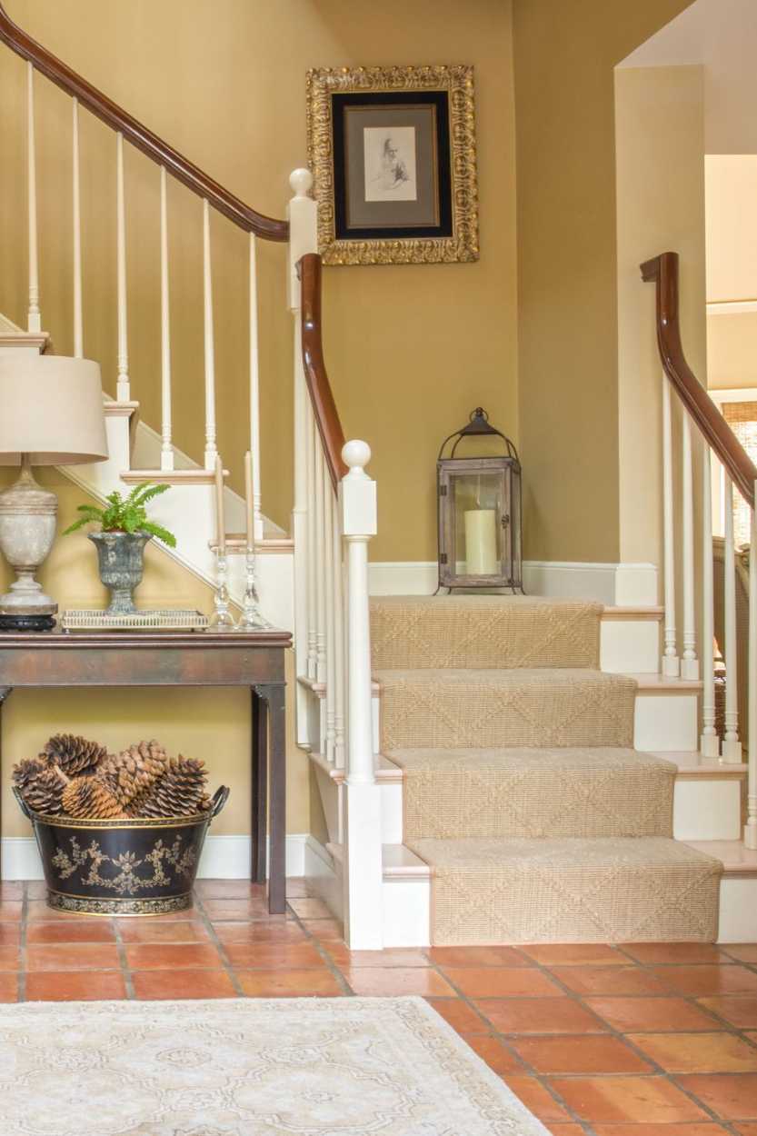 Bright stair landing with white walls, sheer curtains, and natural wood, airy and open