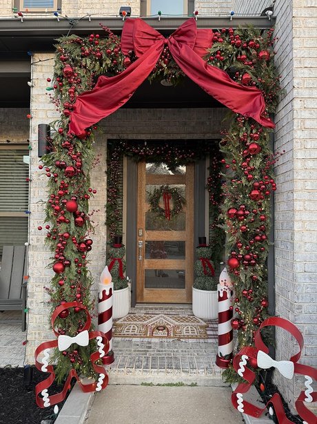 A farmhouse kitchen window decorated with a natural dried orange slice and cinnamon stick garland.