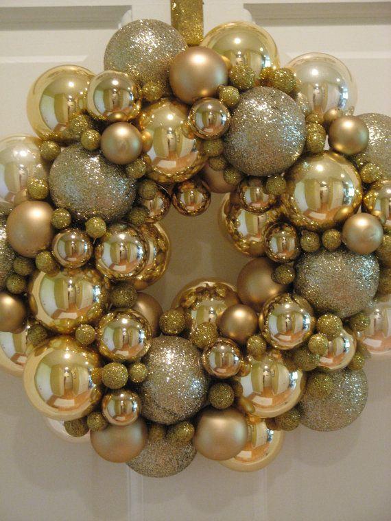Dining table decorated with gold christmas decor, white linen, and modern gold cutlery set.