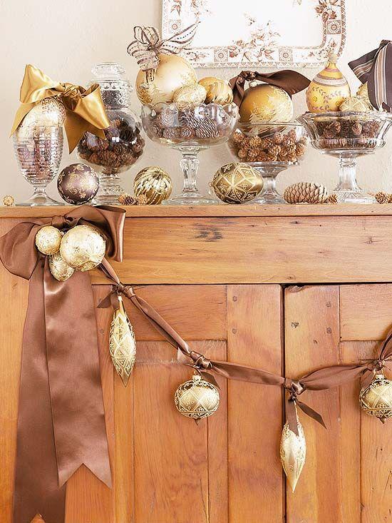 Modern kitchen island styled with gold christmas decor, eucalyptus, and ceramic white bowls.