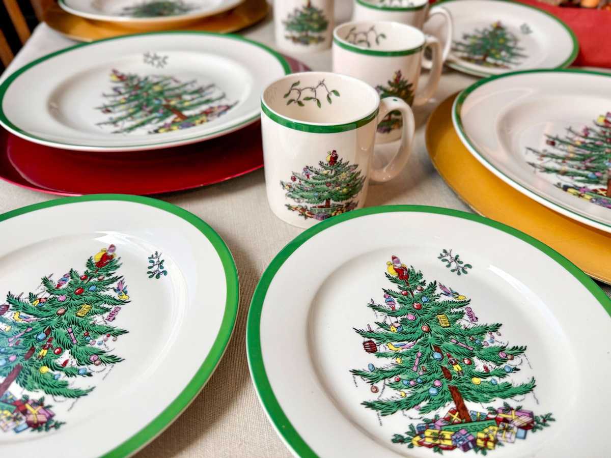 Traditional christmas china pattern with silver bells and ribbon motifs on white plates.