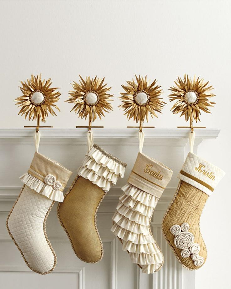 Window sill styled with gold christmas decor, brass lanterns, and hanging gold stars.