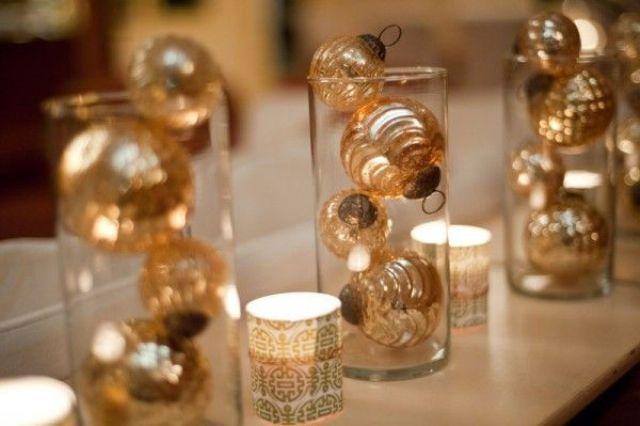 Large gold hoop wreath on a wall, styled with gold christmas decor and greenery.