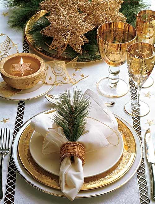 Outdoor patio styled with gold christmas decor, string lights, and gold metal lanterns.