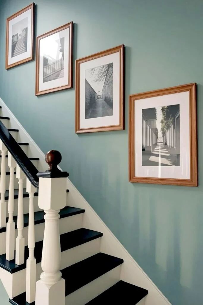 Black and white architectural photography on staircase wall, minimalist frames, soft natural light