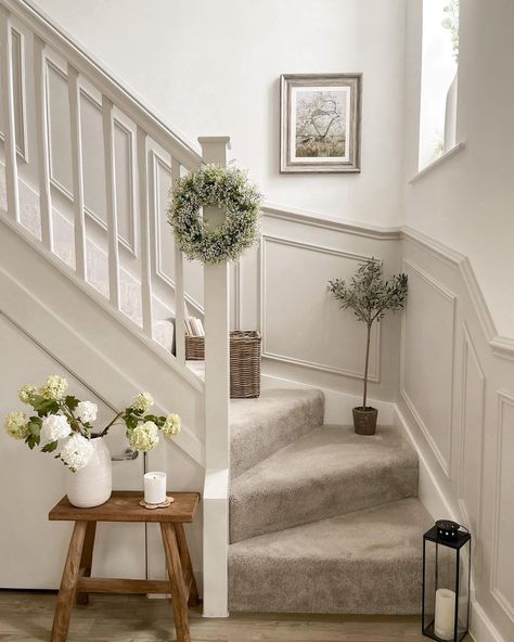 Clean stair landing with single bench, potted plant, and neutral wall, minimalist style