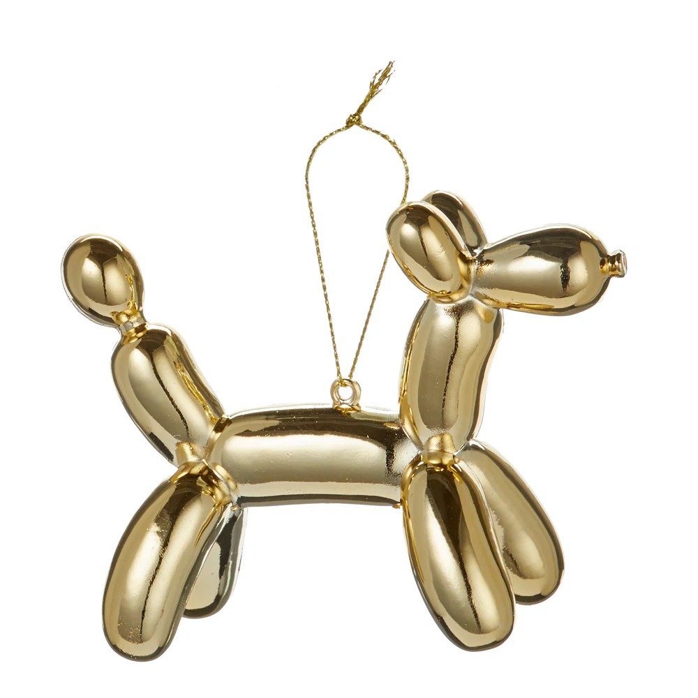 Modern holiday mantel featuring matte mint green balloon giraffe ornament with warm glowing candles nearby.