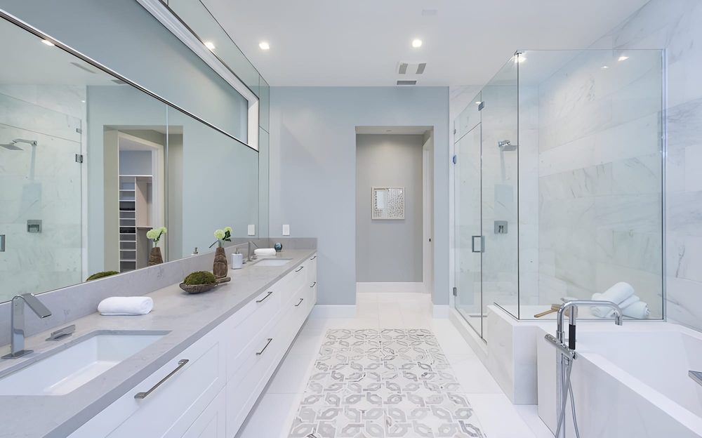 Contemporary bathroom vanity fluted oak cabinet quartz countertop sleek brushed gold faucets soft ambient wall sconces.