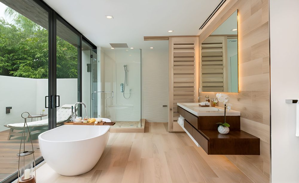Terracotta bathroom walls unlacquered brass exposed plumbing terracotta floor tile soft 2700K lighting.