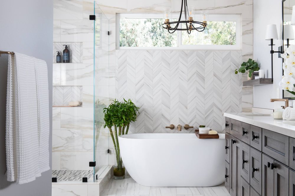 Powder room botanical tropical wallpaper deep forest green beadboard paneling warm antique brass vanity light.