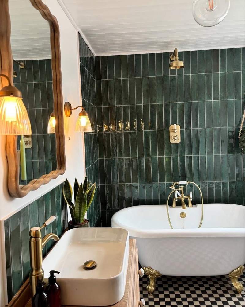 Playful terrazzo tile walk in shower warm honey wood vanity matte black shower fixtures soft overhead light.