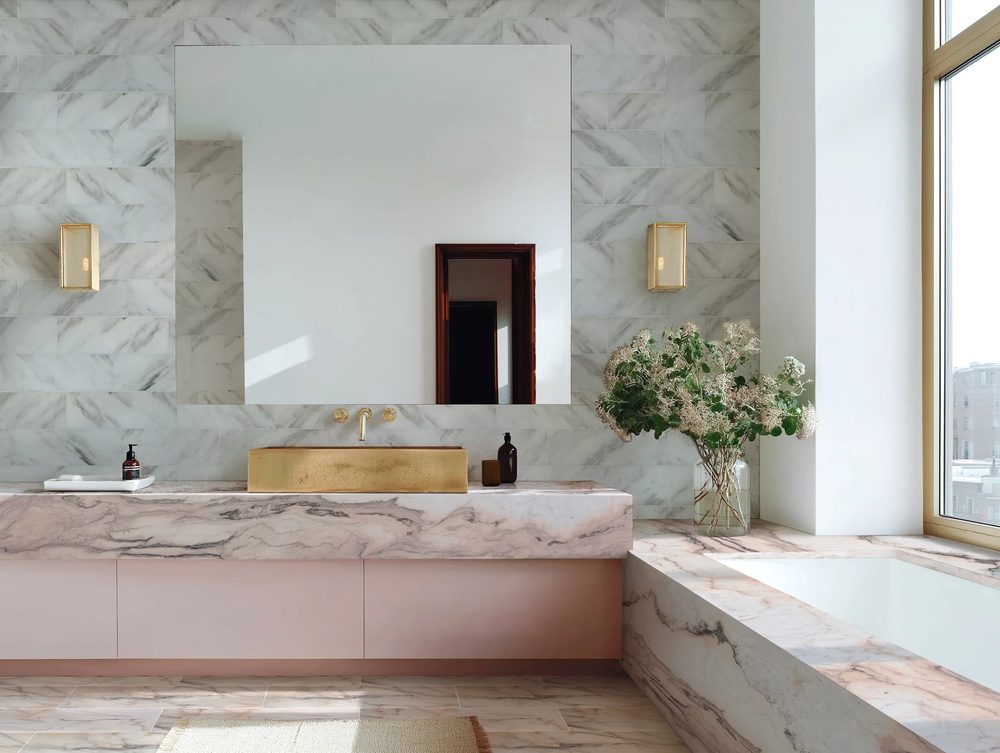 Walk in shower floating stone bench ceiling rainfall head soft recessed ledge lighting microcement walls.