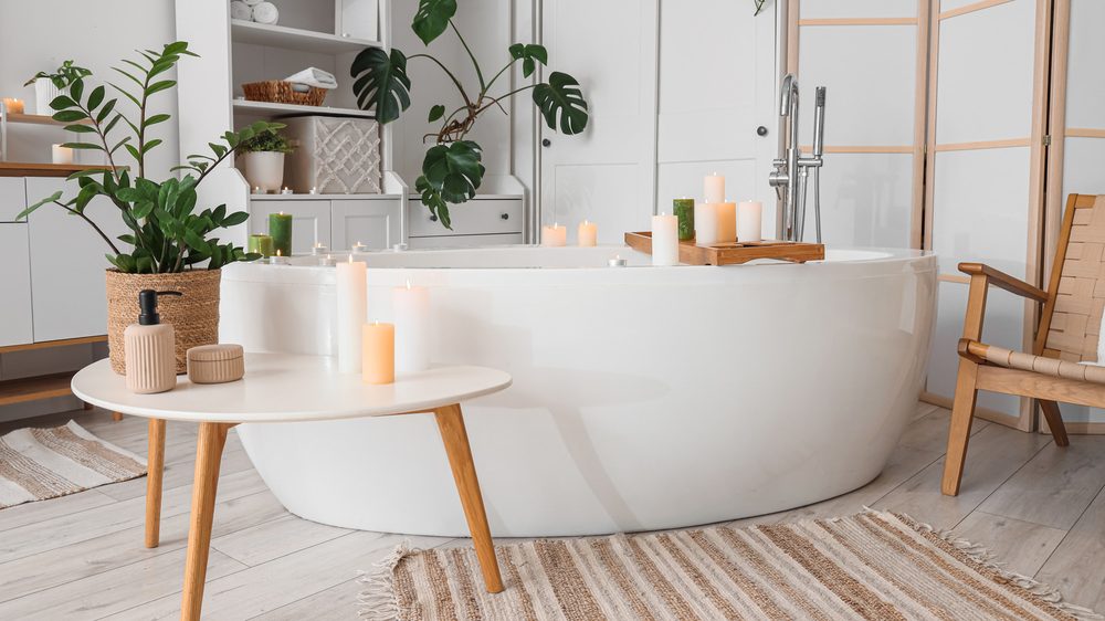 Bathroom vanity featuring brushed brass faucets and drawer pulls against navy blue cabinets.