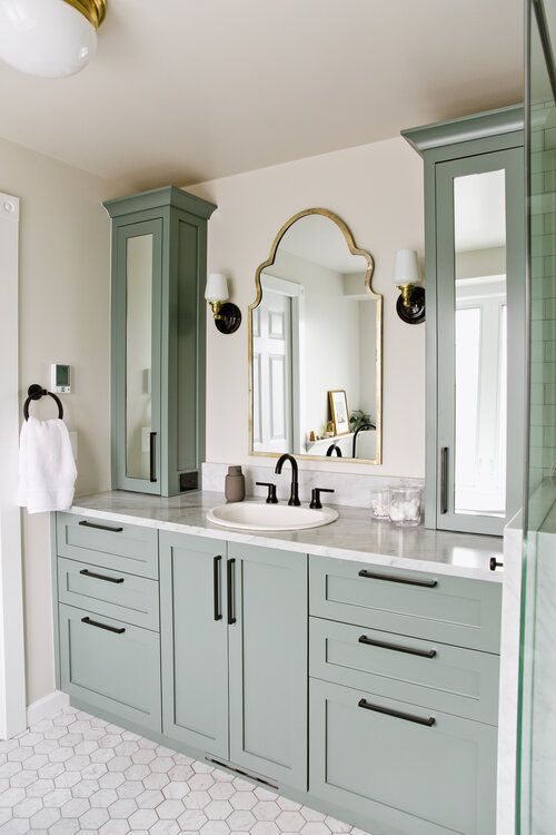 Bathroom floor featuring bold black and white geometric patterned mosaic tiles.