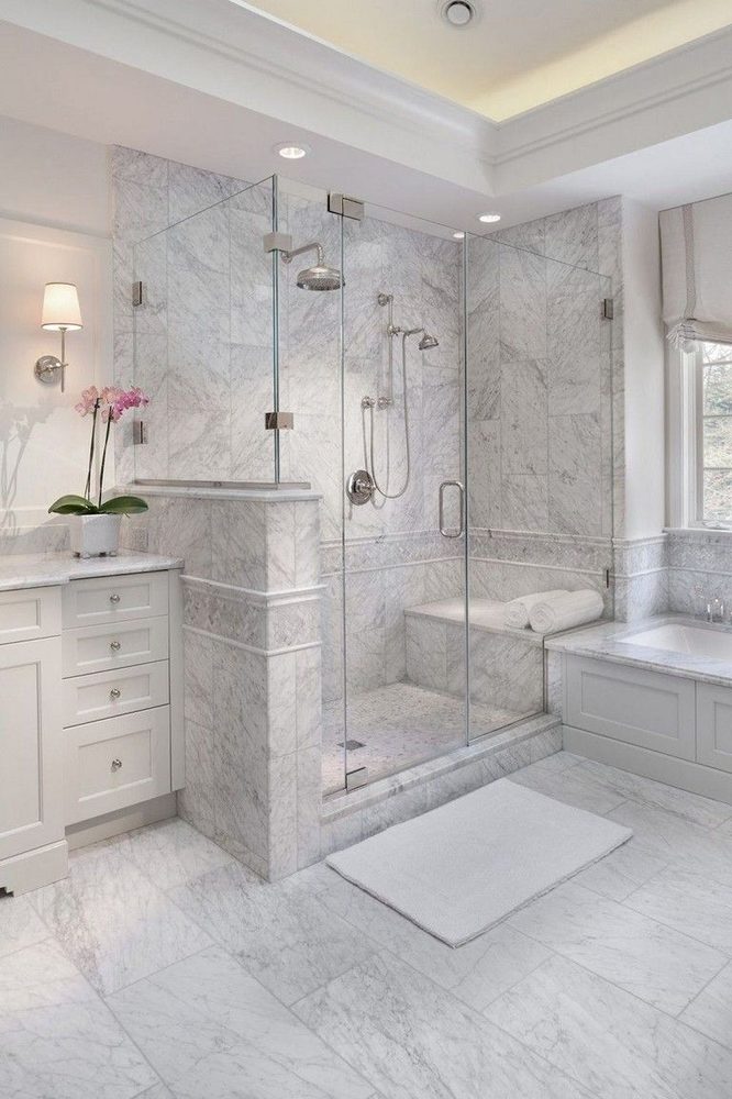 Bathroom featuring a large, modern glass pendant light hanging above the central vanity area.