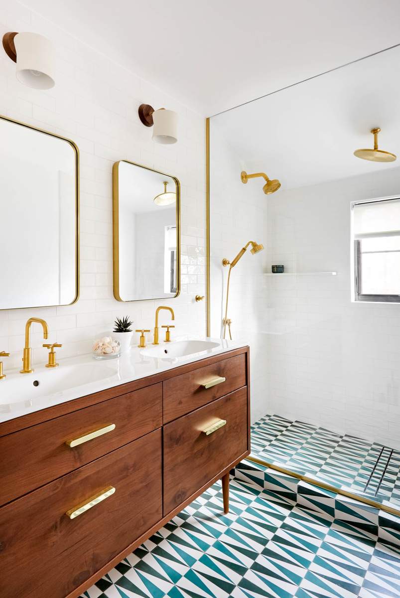 Master bathroom with two identical rectangular mirrors, dark navy vanity, and polished chrome sconces.