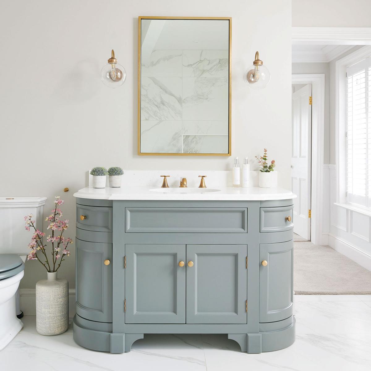 Practical bathroom with a recessed medicine cabinet mirror, marble tile, and hidden storage.