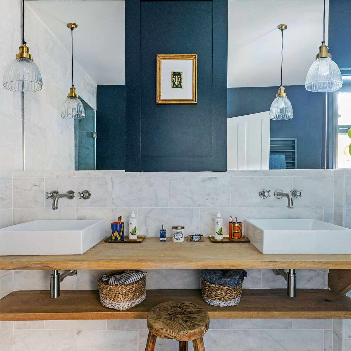 Traditional bathroom with a wall-mounted pivoting mirror, porcelain sink, and brass hardware.