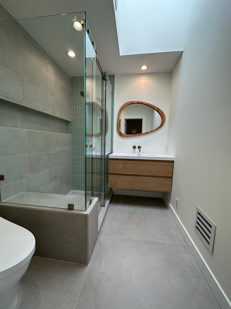 A modern smart mirror with integrated LED edge lighting in a tech-forward bathroom.
