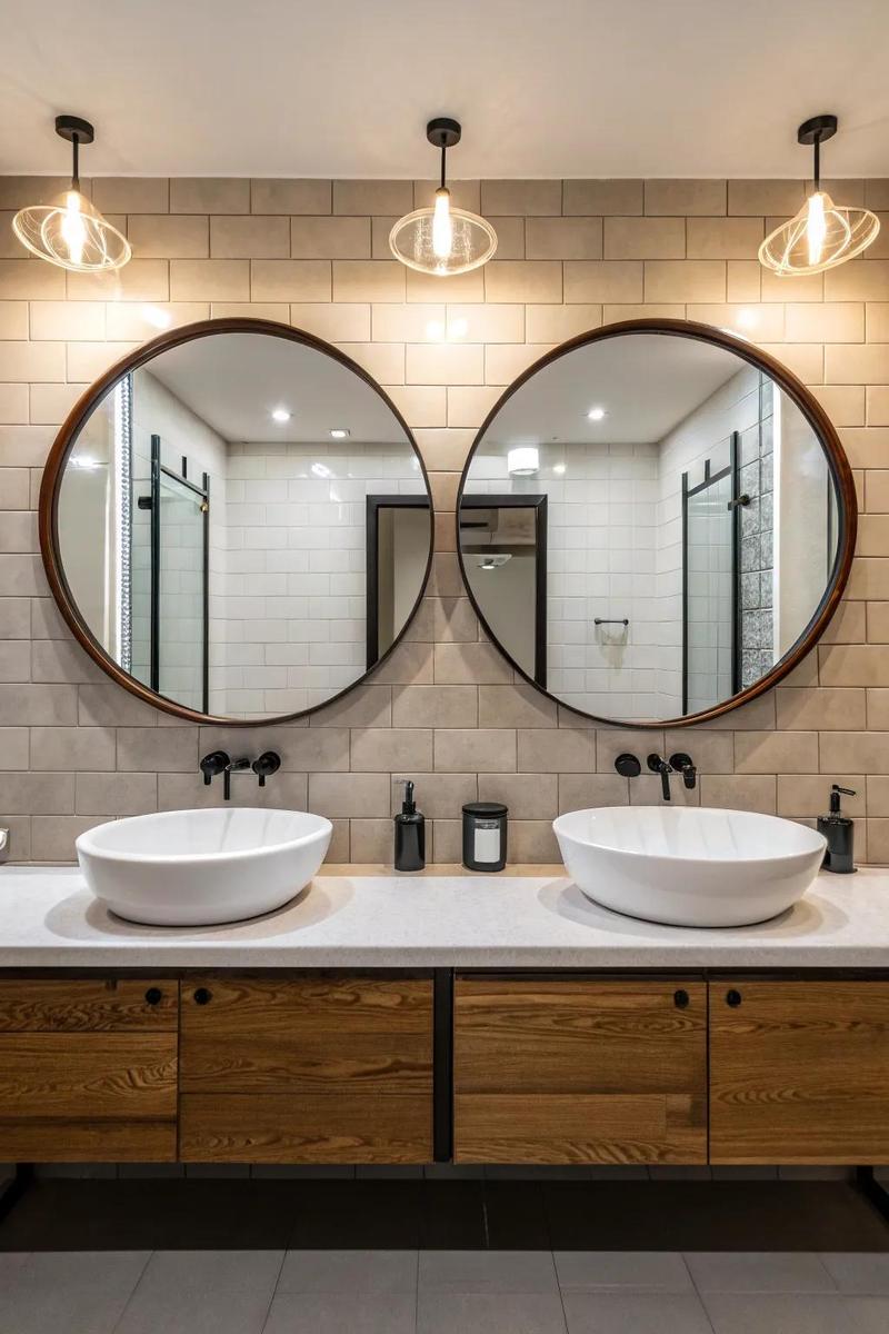 Three matching arched mirrors mounted in a row above a long triple vanity.