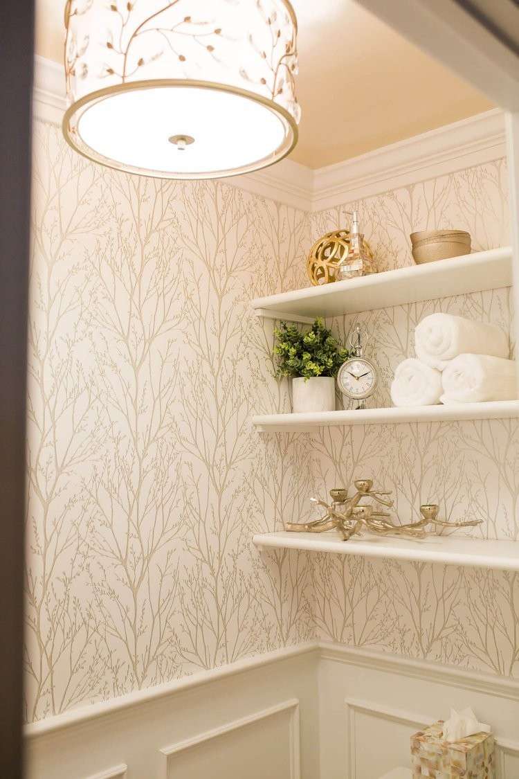 Small bathroom alcove with beige textured wallpaper marble vanity unit warm overhead lighting accents.