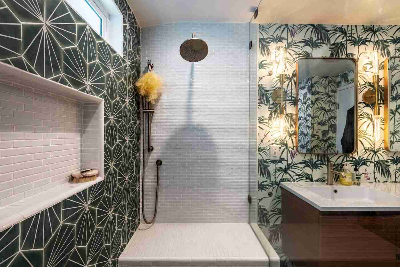Bathroom shower area featuring lush green botanical wallpaper with glass shower enclosure.