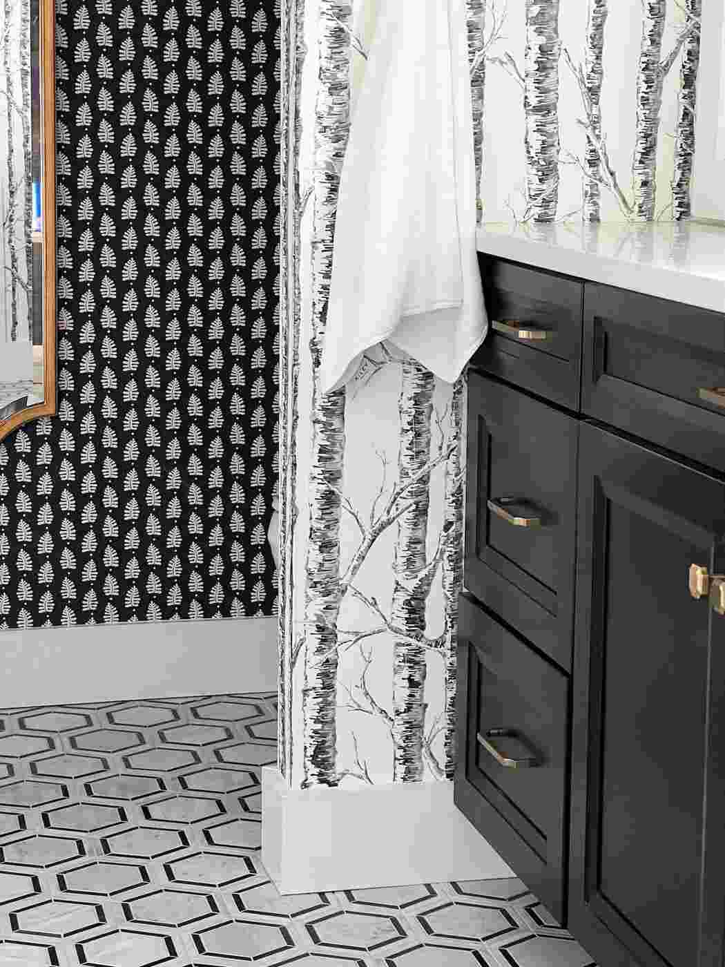 Modern bathroom with black and white geometric wallpaper and minimalist features.
