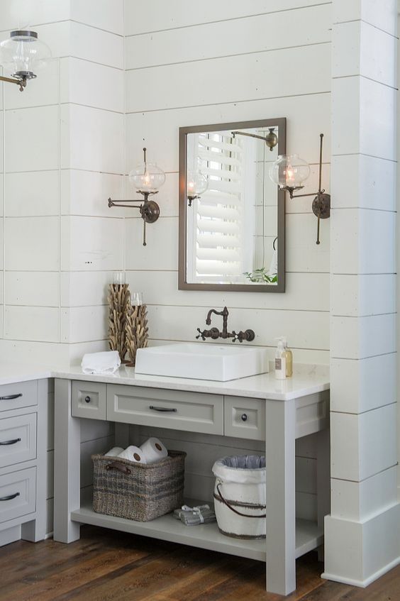 Bathroom featuring white shiplap walls with a textured floral wallpaper accent.