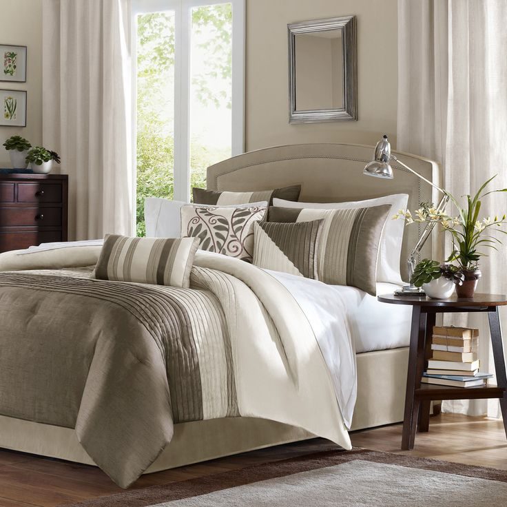 Bright white cozy bedroom with layered white duvet, chunky knit blanket, soft warm backlighting, upholstered bed