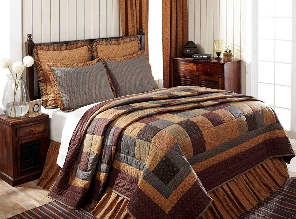French country bedroom featuring blue ticking stripe duvet cover, upholstered headboard, and soft lighting.