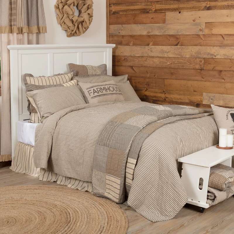 Rustic bedroom with olive green linen duvet, burnt sienna throw, reclaimed wood frame, soft lighting.