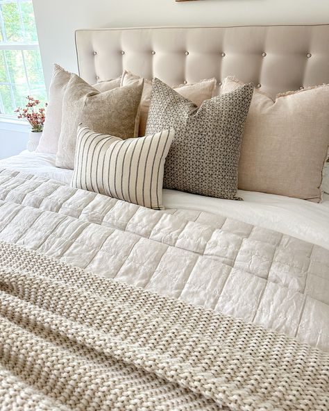 Cottage bedroom with wrought iron bed, sage green botanical bedding, soft window sunlight glow.