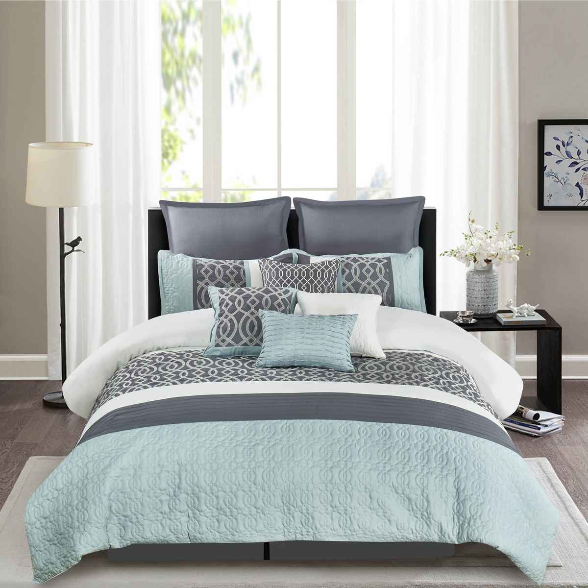 Romantic bedroom with padded dark headboard, plum velvet duvet bedding, soft warm bedside lamp lights.