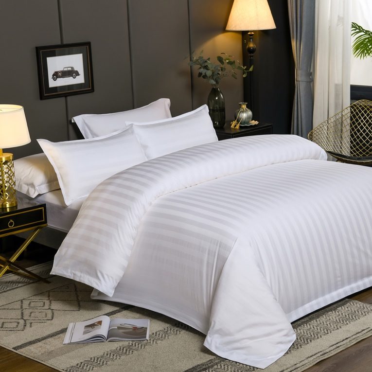 Earthy boho bedroom featuring terracotta bedding set, beige boucle throw, warm rattan bedside lamp illumination.