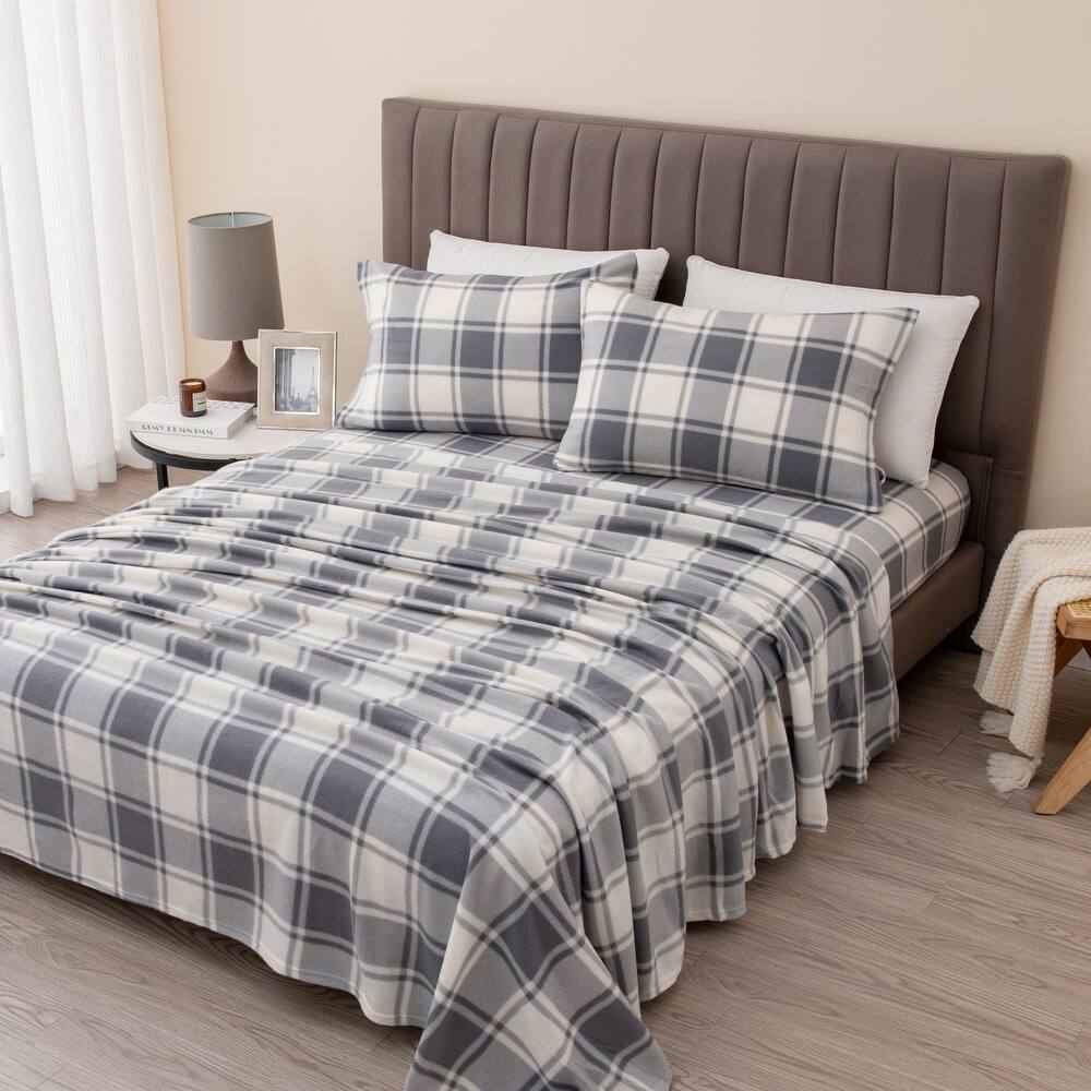 Cozy Scandinavian bedroom with off-white cotton bedding set, chunky wool throw, soft warm wooden lighting.