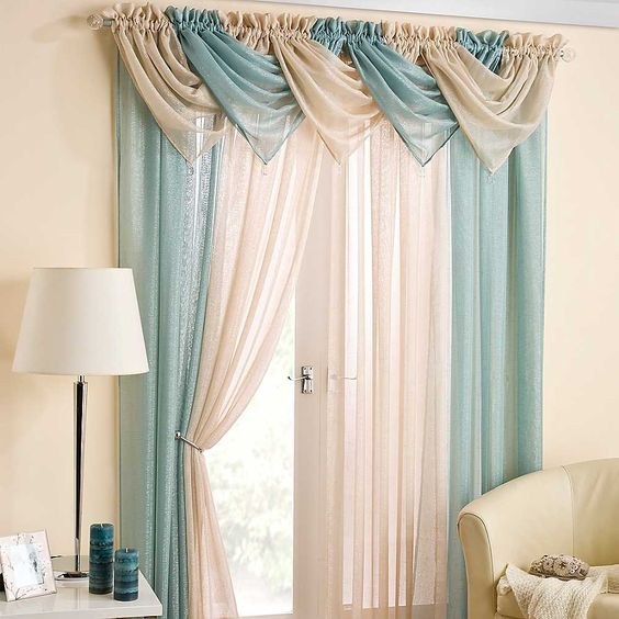 Layered bamboo blinds and beige linen curtains in a minimalist bedroom with rattan furniture.