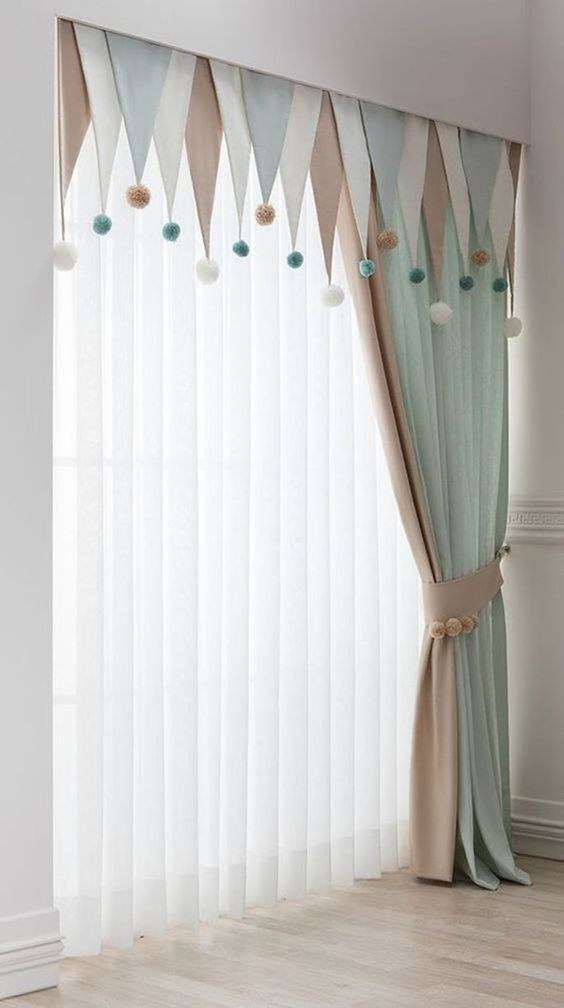 White curtains with pom-pom or tassel trim in a bohemian bedroom with rattan decor.