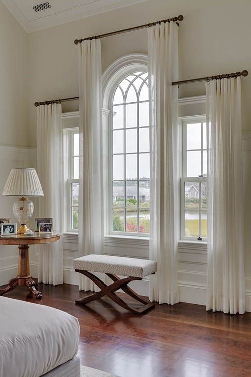 Beige blackout-lined linen curtains in a serene bedroom with a platform bed.