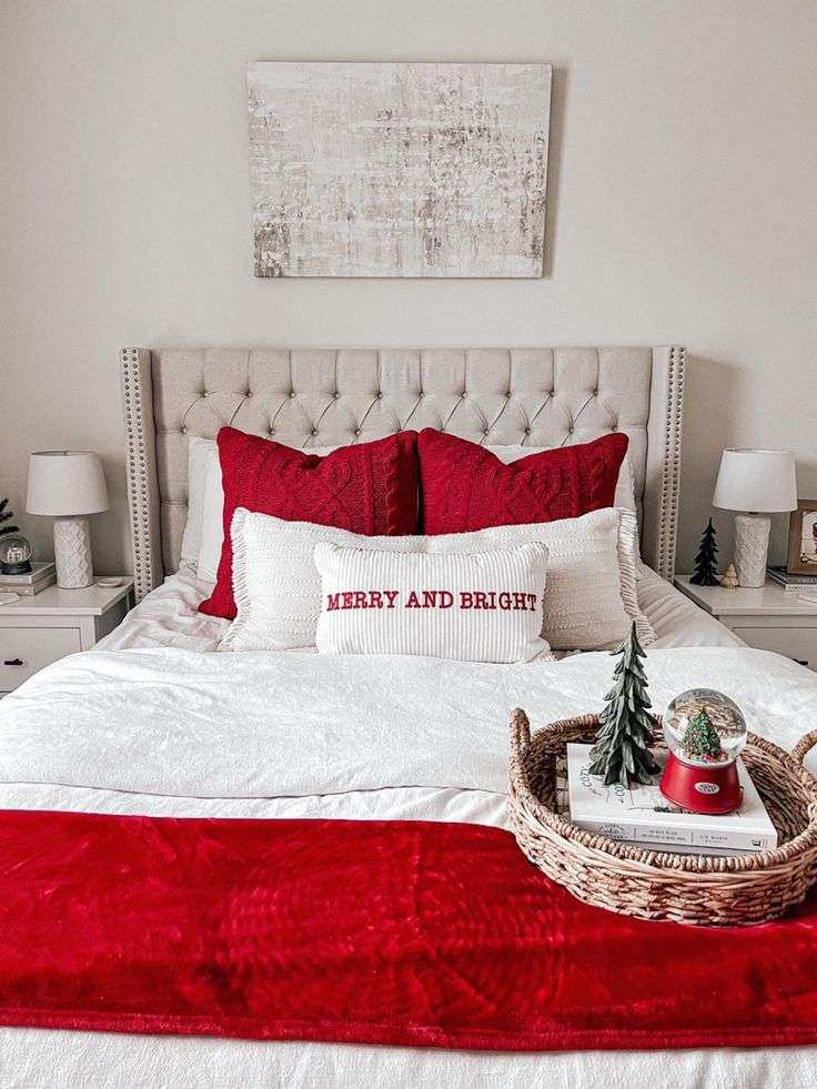 Bedroom with a deep red duvet cover, white linen sheets, and a plush faux‑fur throw at the foot of the bed.