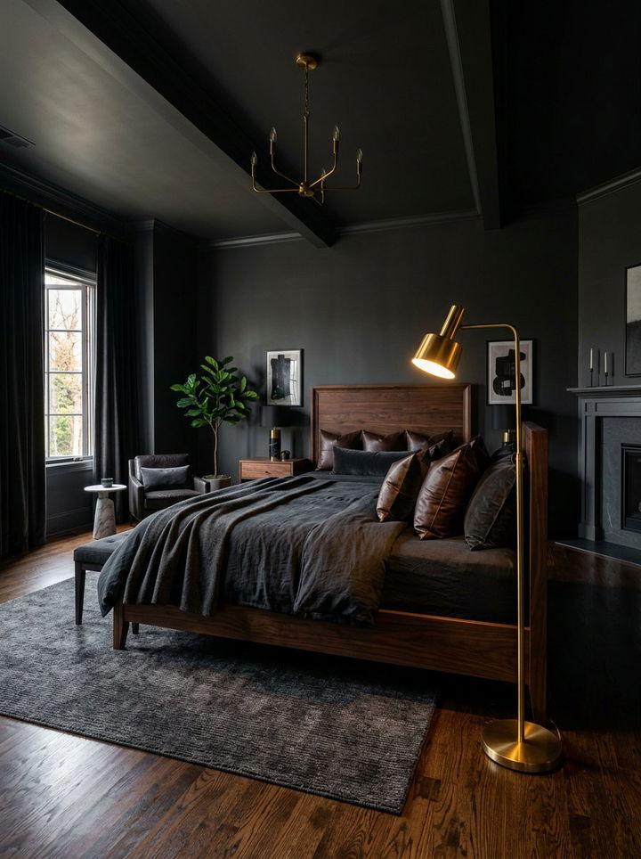 Black bedroom featuring a dark wood platform bed, brass chandelier, stone fireplace, and muted wall finishes.