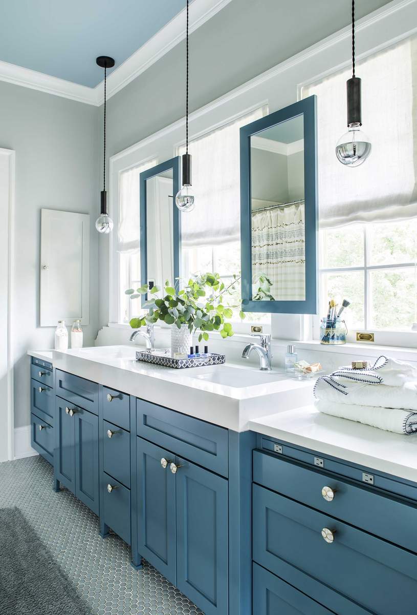 Slate blue double vanity featuring glass drop pendant lights brushed brass hardware and white marble