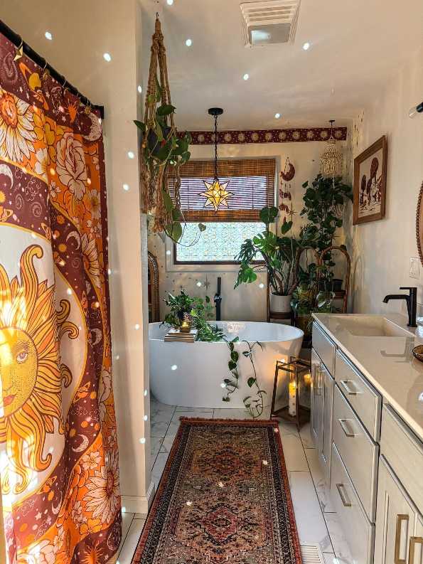 Bohemian bathroom showcasing a sun‑patterned shower curtain, freestanding tub, woven basket, and natural wood accents.