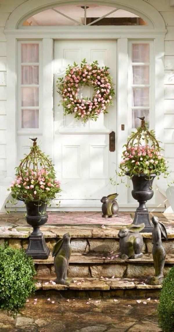 Front porch with yellow metal chairs, white rattan table, and pastel flower pots