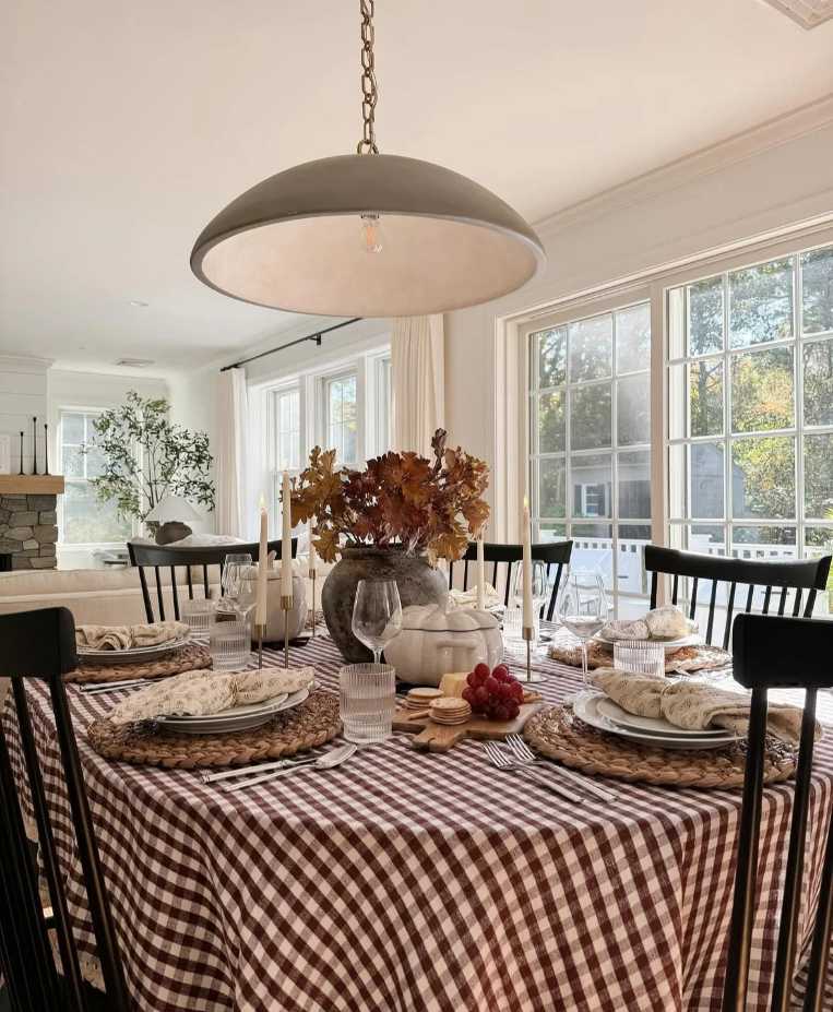 Farmhouse kitchen, burgundy gingham runner, woven linen placemats, copper flatware, amber lighting